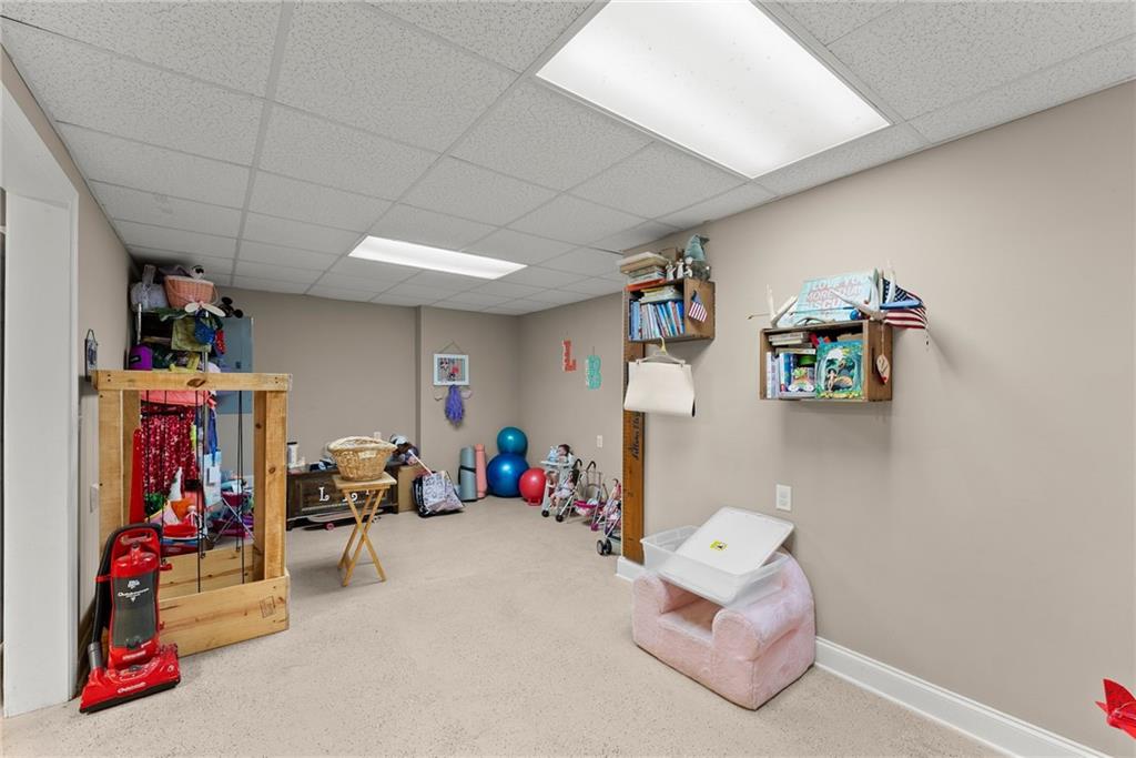 1617 Edwards Mill Road Ball Ground, GA 30107 - Photo 29 of 42 a living room with lots of furniture and clutter