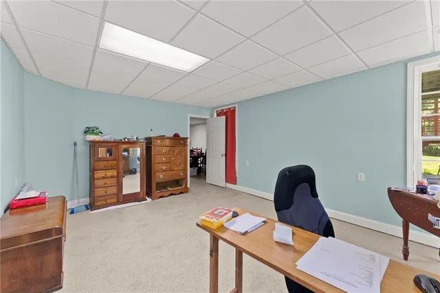 an aerial view of a house with a yard and lake view