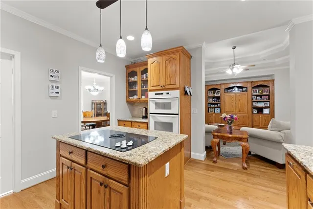 a kitchen with granite countertop a sink stove and refrigerator