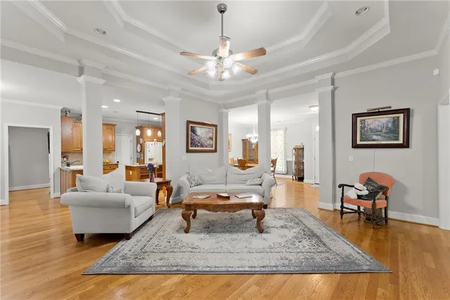 a living room with furniture a chandelier and a fireplace