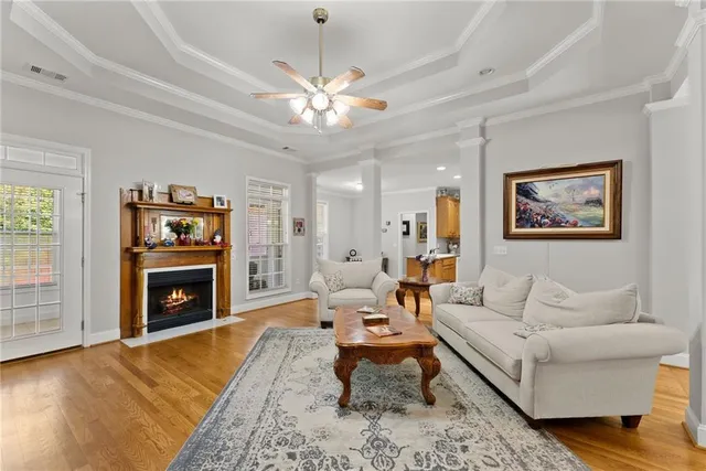 a living room with furniture ceiling fan and a window