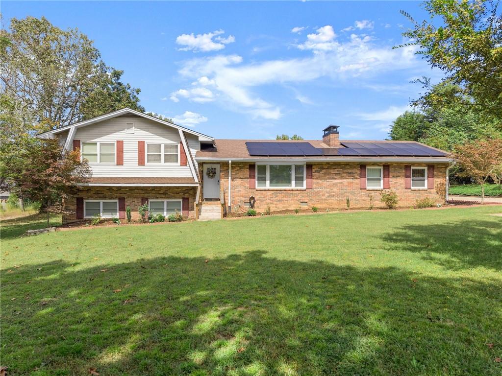 a front view of a house with a garden