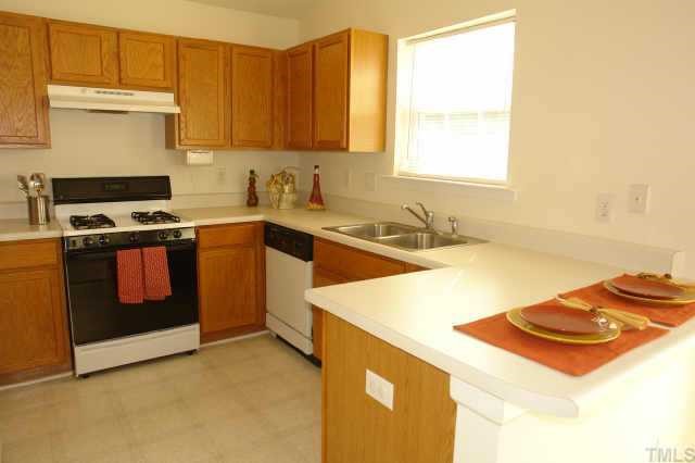 5525 Gateway Place Raleigh, NC 27617 - Photo 4 of 10 a kitchen with a sink stove and cabinets