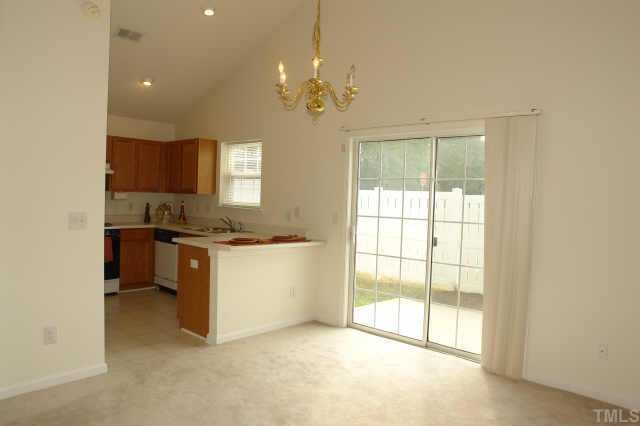 5525 Gateway Place Raleigh, NC 27617 - Photo 5 of 10 a kitchen that has a lot of cabinets and wooden floor