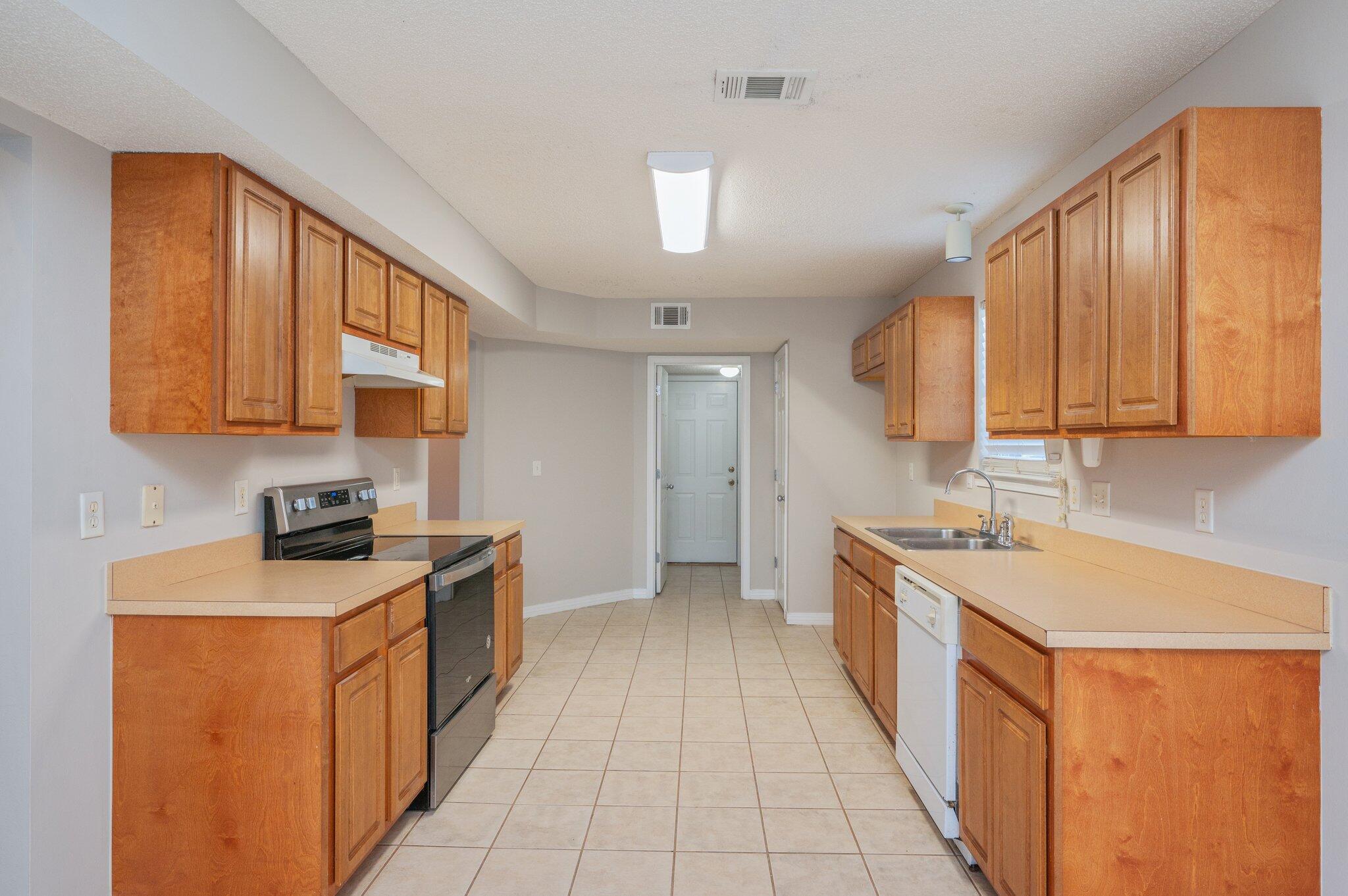 546 Tikell Drive Crestview, FL 32536 - Photo 7 of 20 a kitchen with a sink stove and cabinets