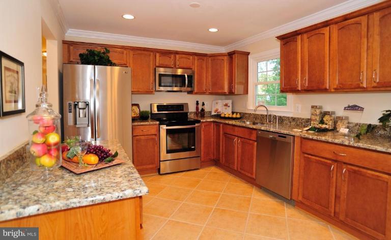 6806 Ben Franklin Road Springfield, VA 22150 - Photo 11 of 21 a kitchen with stainless steel appliances granite countertop a sink stove and refrigerator