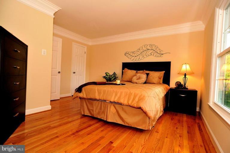 6806 Ben Franklin Road Springfield, VA 22150 - Photo 6 of 21 a bedroom with a bed and a night stand