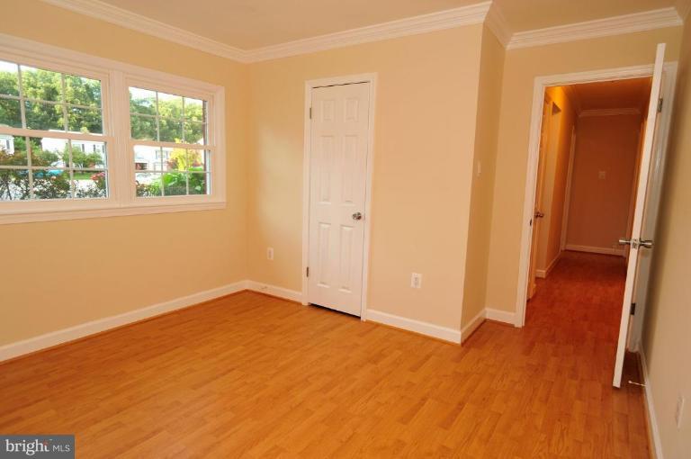 6806 Ben Franklin Road Springfield, VA 22150 - Photo 9 of 21 an empty room with wooden floor and windows