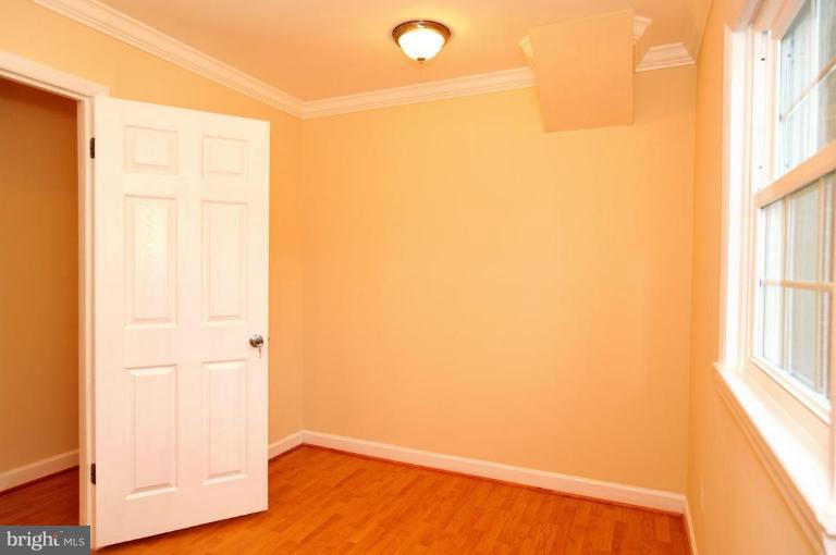 6806 Ben Franklin Road Springfield, VA 22150 - Photo 10 of 21 a view of empty room with wooden floor and fan