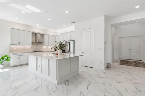 a kitchen with stainless steel appliances a refrigerator sink and cabinets
