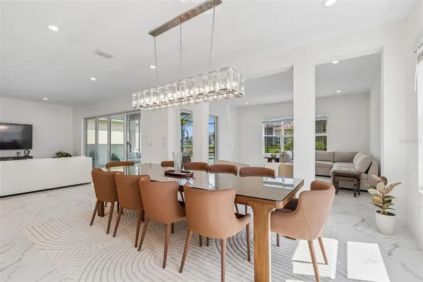 a view of a hallway with wooden floor and windows