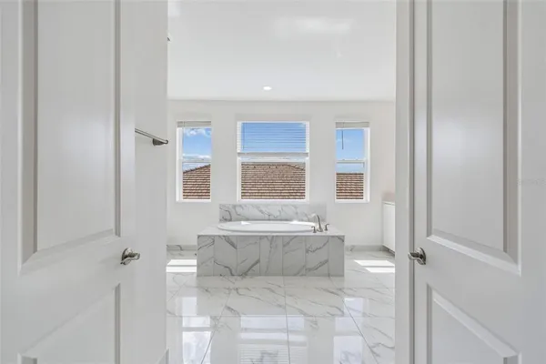 a bed room with a bed and a chair