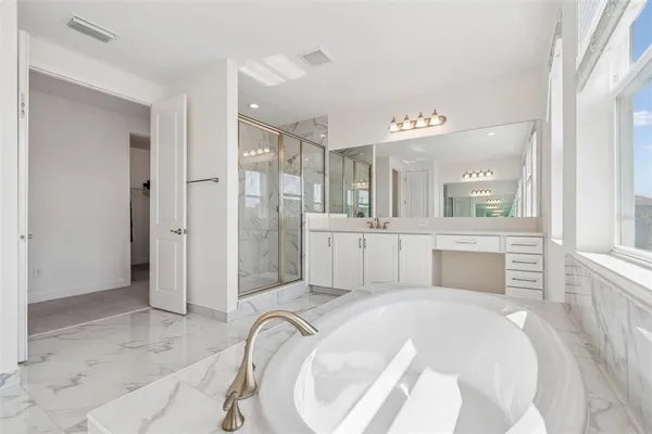 a bedroom with a bed and glass door