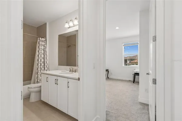 a front view of a house with a garden and lake view