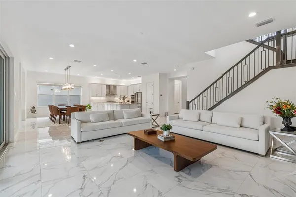 a kitchen with stainless steel appliances a refrigerator sink and cabinets