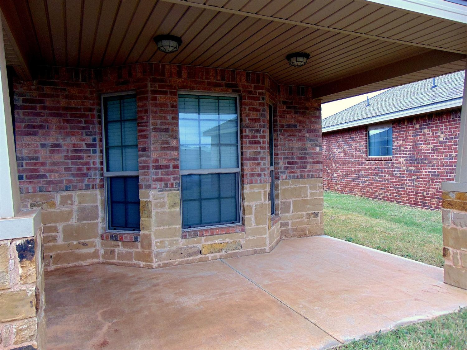 9708 Remington Avenue Lubbock, TX 79424 - Photo 3 of 10 a view of a brick house with a large window