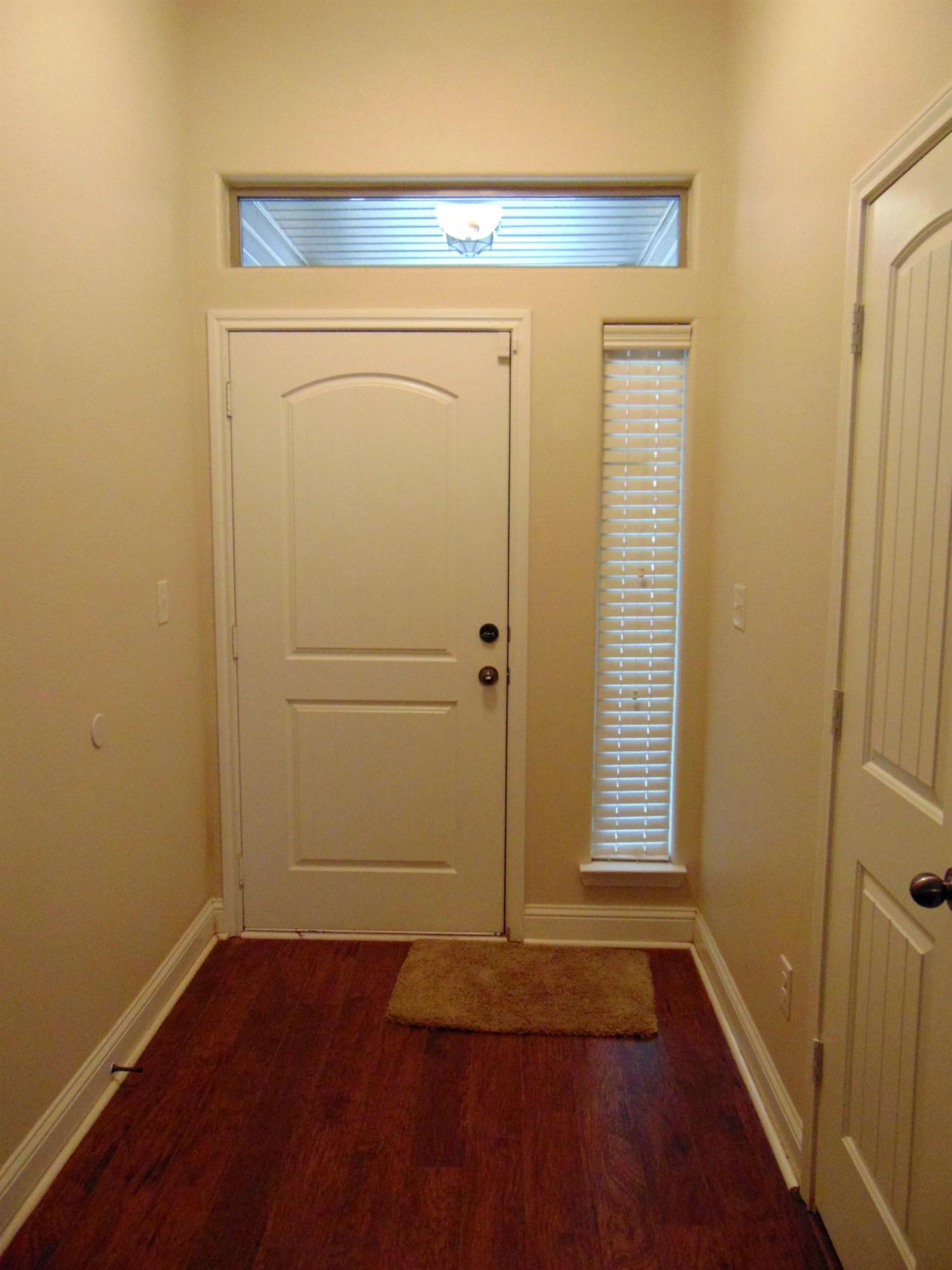 9708 Remington Avenue Lubbock, TX 79424 - Photo 4 of 10 an entryway door with wooden floor