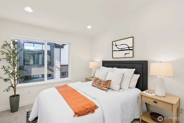 a bedroom with a bed and a large window