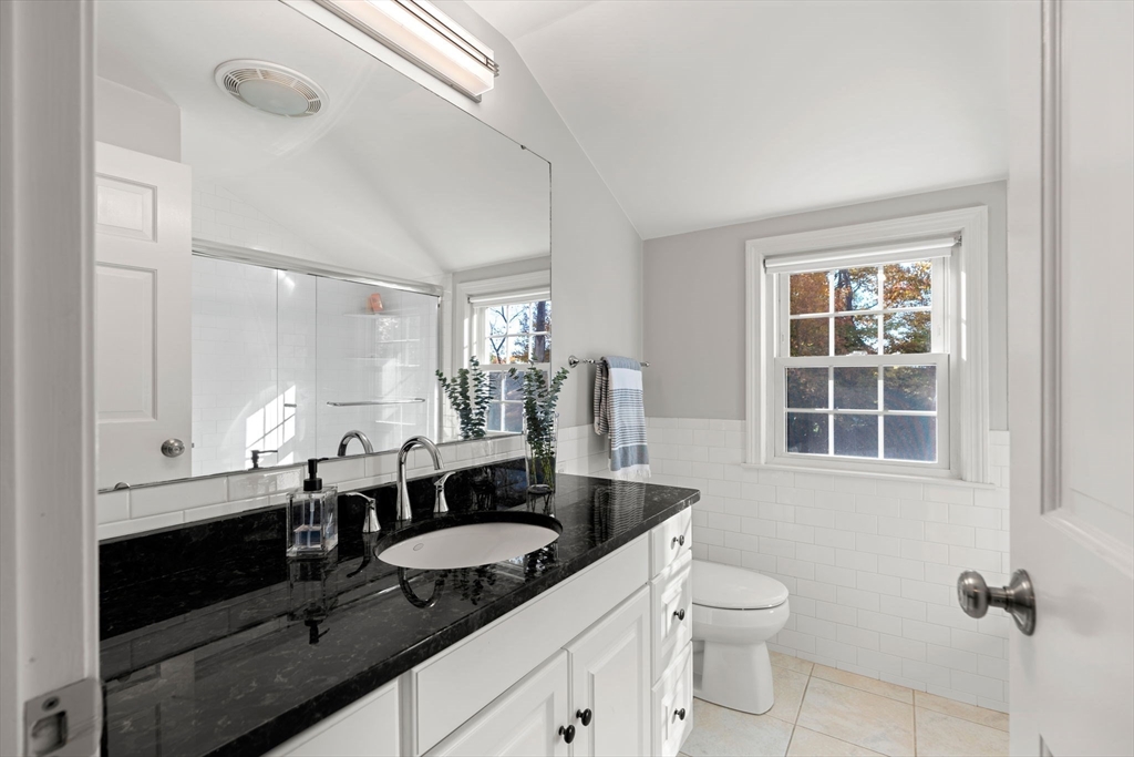 5 Fulton Road Andover, MA 01810 - Photo 20 of 27 a bathroom with a granite countertop sink a mirror and a toilet