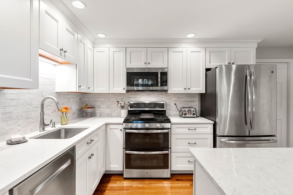5 Fulton Road Andover, MA 01810 - Photo 6 of 27 a kitchen with a stove a refrigerator and a sink
