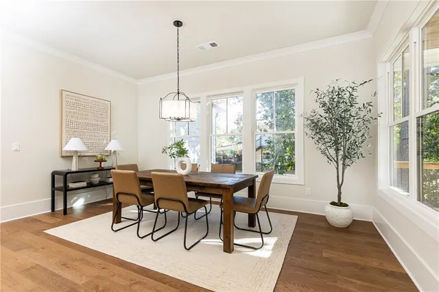 a open kitchen with stainless steel appliances granite countertop a stove a sink a oven a dining table chairs and view of living room