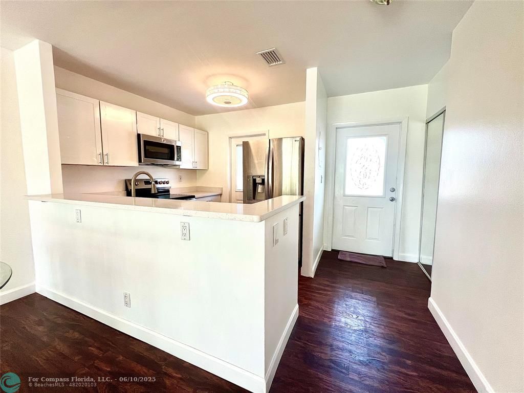 5001 West Oakland Park Boulevard, Unit 111 Lauderdale Lakes, FL 33313 - Photo 1 of 38 a kitchen with stainless steel appliances a refrigerator sink and microwave