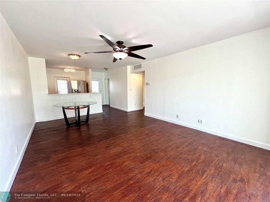 5001 West Oakland Park Boulevard, Unit 111 Lauderdale Lakes, FL 33313 - Photo 11 of 38 a view of a work space with wooden floor and a ceiling fan