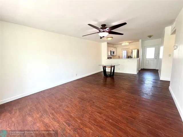 a view of a livingroom with a hardwood floor and a ceiling fan