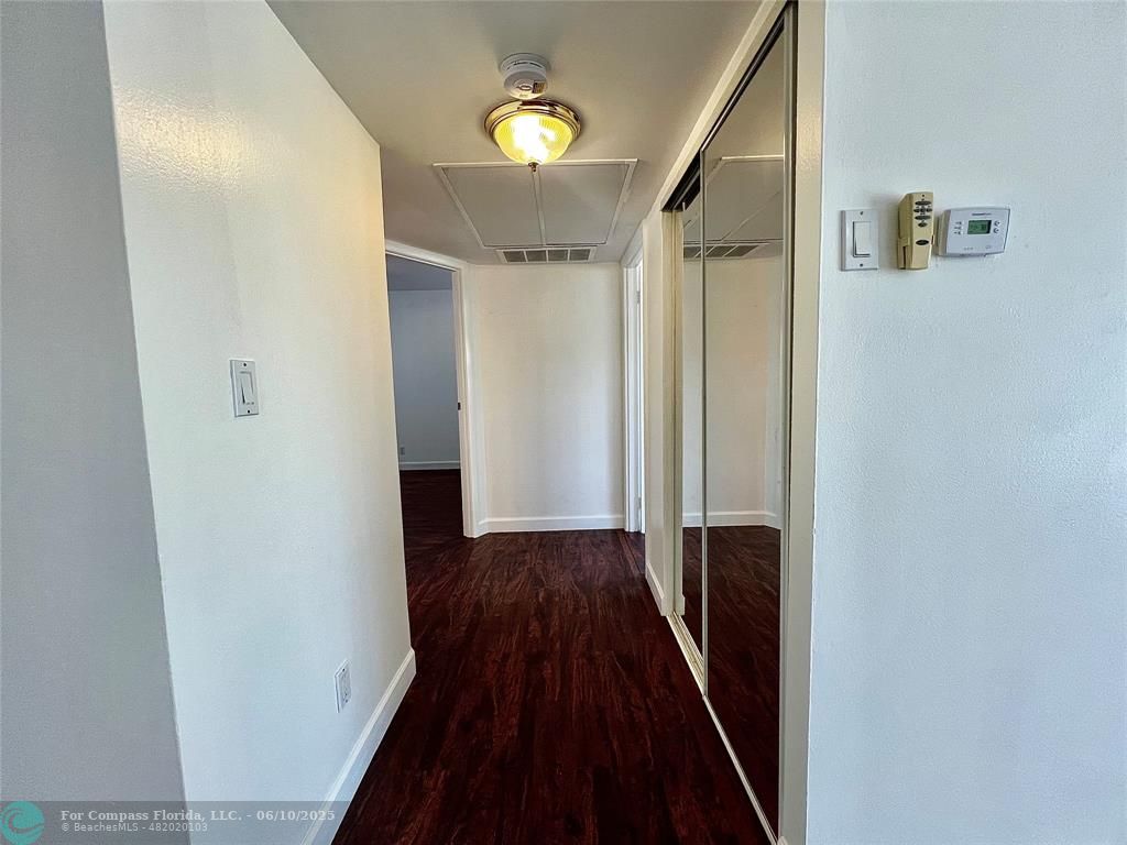 5001 West Oakland Park Boulevard, Unit 111 Lauderdale Lakes, FL 33313 - Photo 18 of 38 a view of a hallway with wooden floor and staircase
