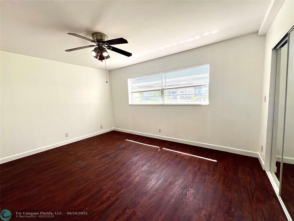 5001 West Oakland Park Boulevard, Unit 111 Lauderdale Lakes, FL 33313 - Photo 19 of 38 wooden floor in an empty room with a window