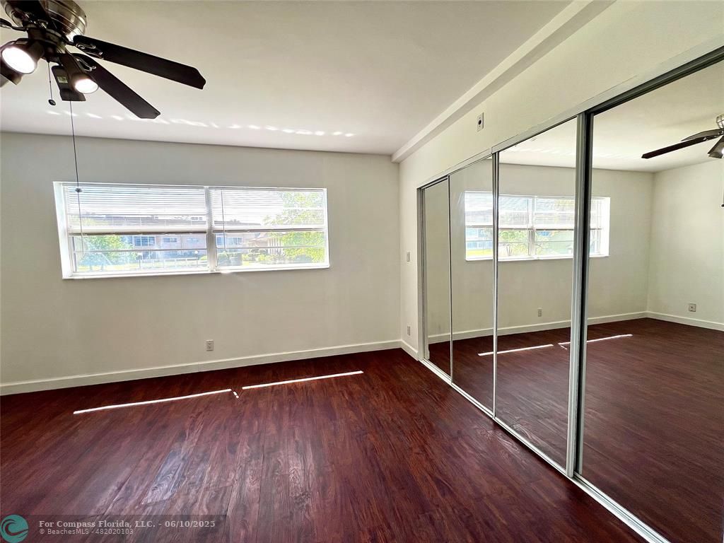 5001 West Oakland Park Boulevard, Unit 111 Lauderdale Lakes, FL 33313 - Photo 20 of 38 a view of empty room with wooden floor and fan