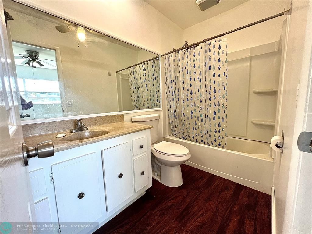 5001 West Oakland Park Boulevard, Unit 111 Lauderdale Lakes, FL 33313 - Photo 23 of 38 a bathroom with a sink a toilet and shower