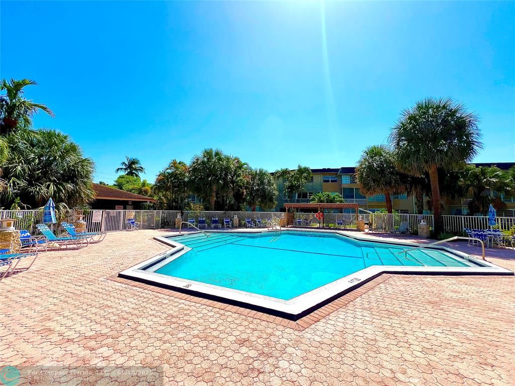 5001 West Oakland Park Boulevard, Unit 111 Lauderdale Lakes, FL 33313 - Photo 29 of 38 a view of a backyard with swimming pool and furniture