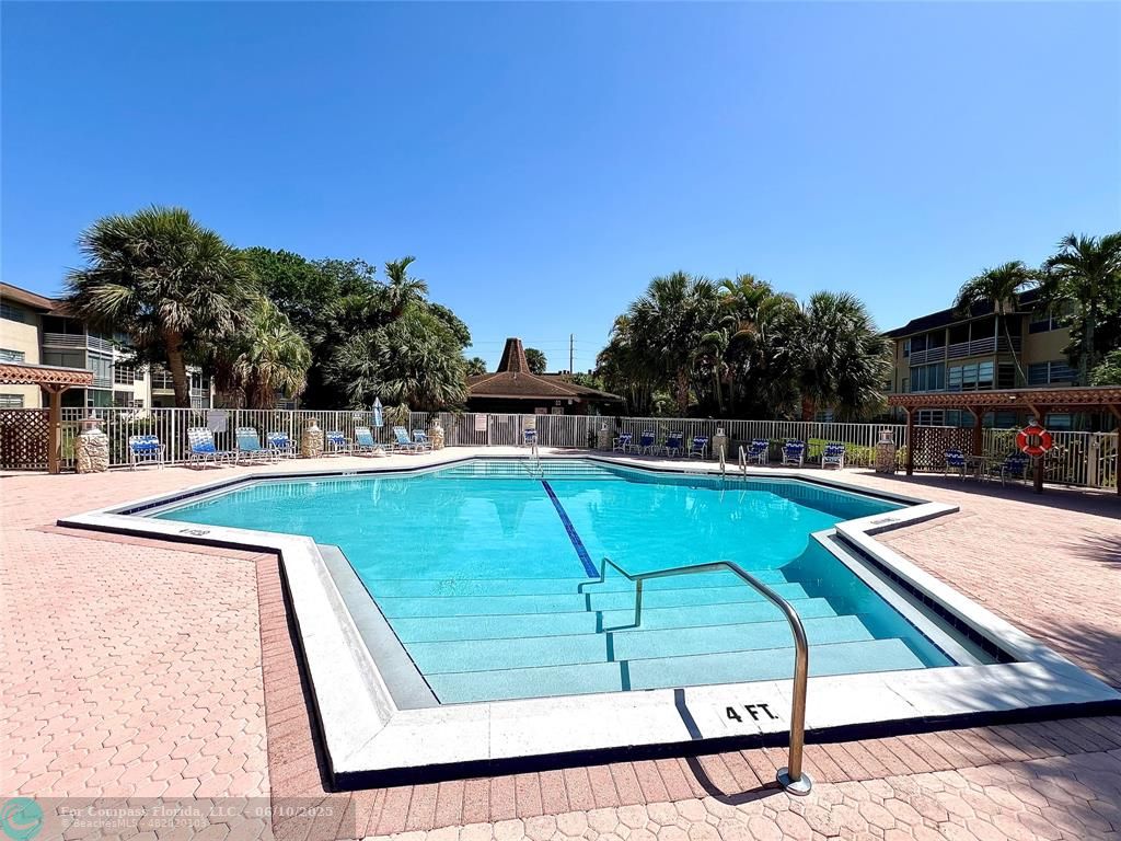 5001 West Oakland Park Boulevard, Unit 111 Lauderdale Lakes, FL 33313 - Photo 30 of 38 a view of a swimming pool with a lounge chair