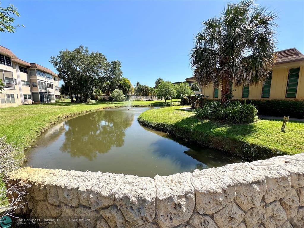 5001 West Oakland Park Boulevard, Unit 111 Lauderdale Lakes, FL 33313 - Photo 35 of 38 a view of a lake with a house in the background