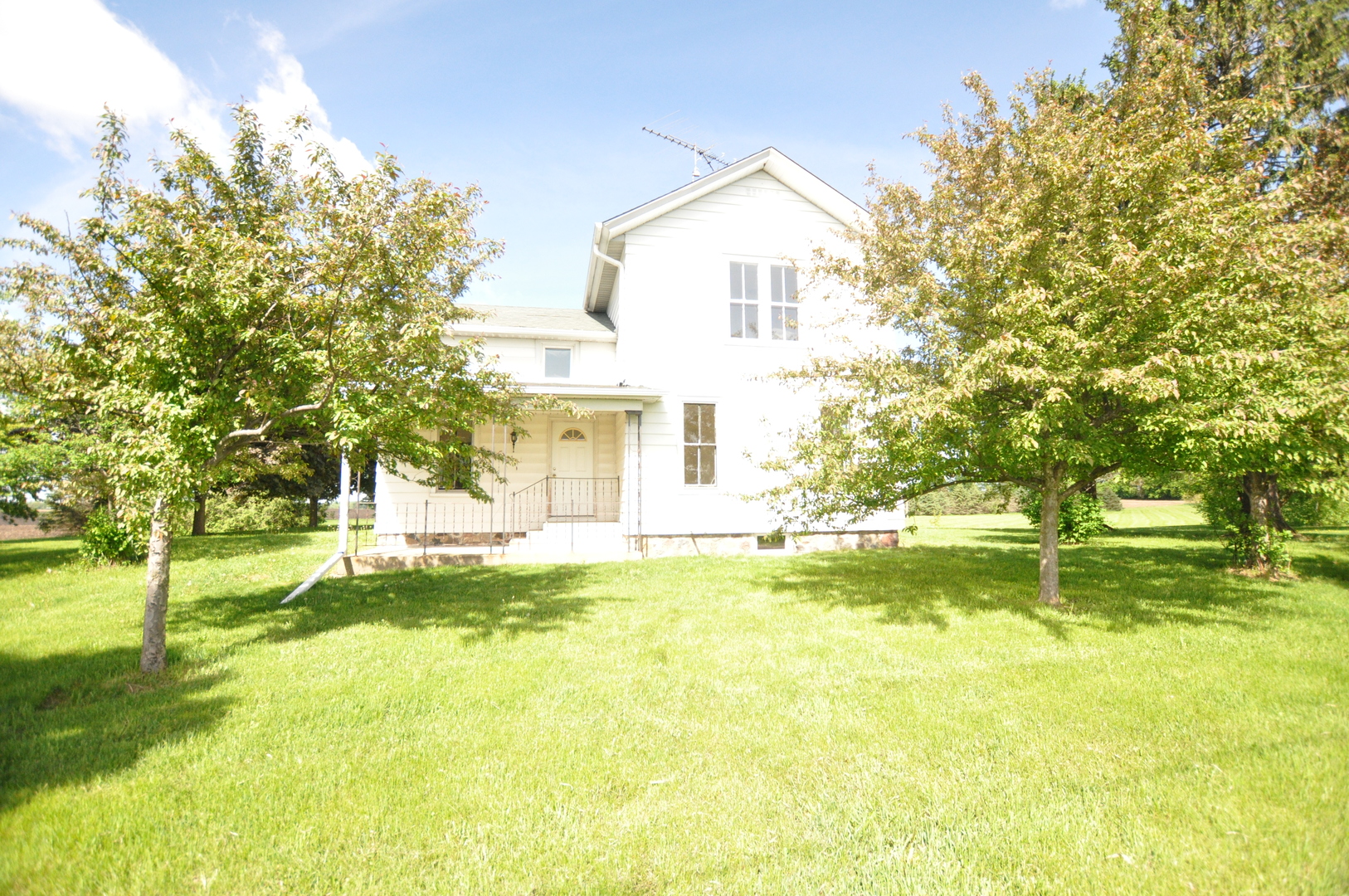 7505 Alden Road Harvard, IL 60033 - Photo 2 of 4 a view of a house with a big yard and a large tree