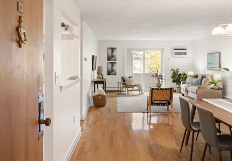 a view of a livingroom with furniture window and wooden floor