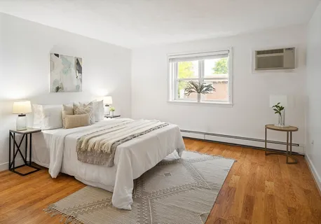 a spacious bedroom with a bed and a window