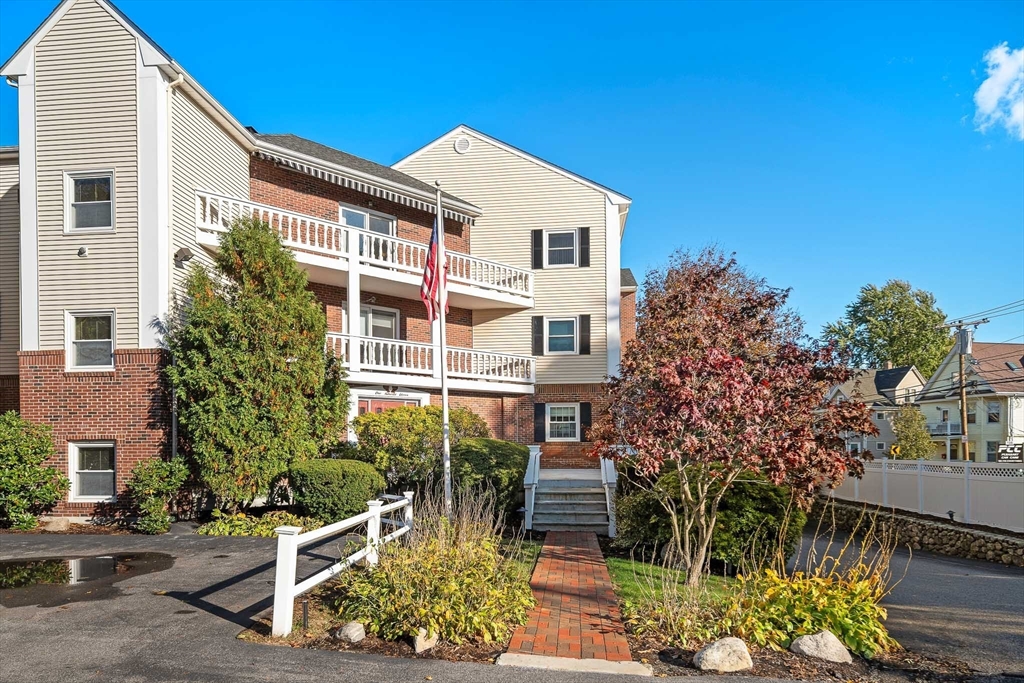 111 Pleasant Street, Unit 24 Watertown, MA 02472 - Photo 19 of 20 a front view of a house with garden