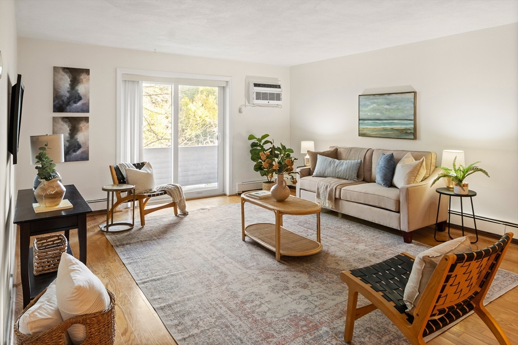 111 Pleasant Street, Unit 24 Watertown, MA 02472 - Photo 3 of 20 a living room with furniture and a potted plant