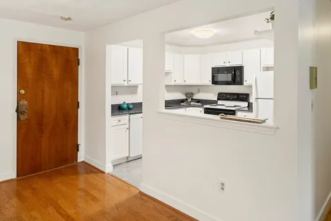 a kitchen with stainless steel appliances a stove a microwave and a refrigerator