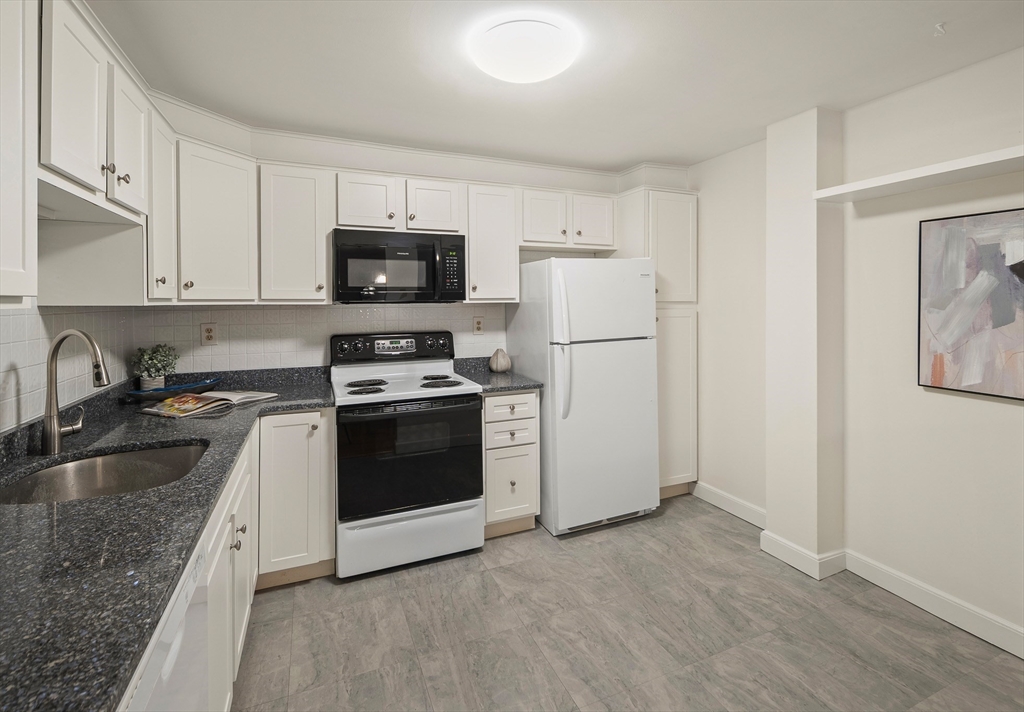 111 Pleasant Street, Unit 24 Watertown, MA 02472 - Photo 6 of 20 a kitchen with a sink stove and refrigerator