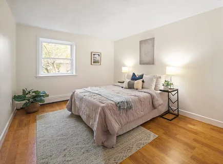 a bedroom with a bed and a potted plant