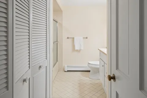 a bathroom with a toilet and a shower