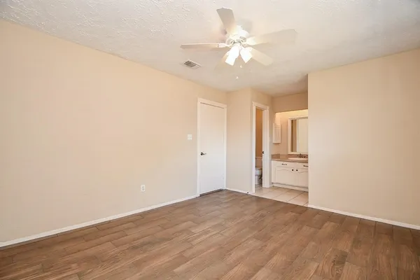 a view of a room with wooden floor