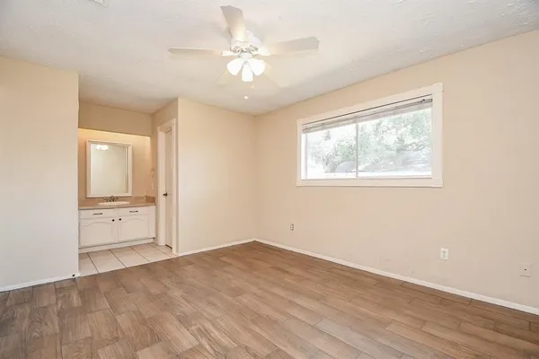 an empty room with a bathroom and a window