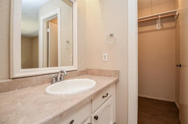 a bathroom with a granite countertop sink and a mirror