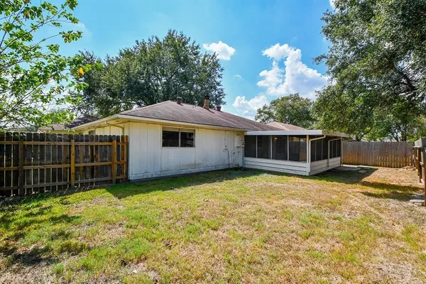 a view of a house with a backyard