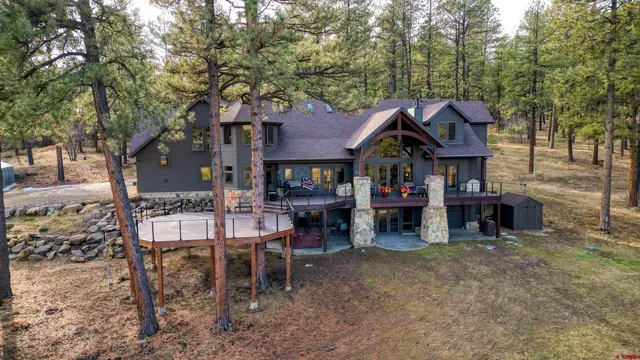 a view of a chairs and tables in the back yard of the house