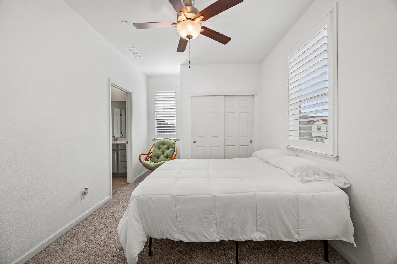 1048 Knox Way Roseville, CA 95747 - Photo 18 of 29 a bedroom with a bed and a chandelier